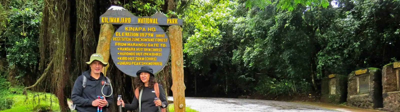 Photo opportunity at the official Marangu Gate signboard for the Kilimanjaro Marangu Route Day Trip.