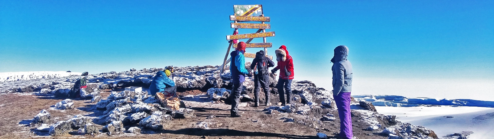 Success at Uhuru Peak summit sign for the 8-day Lemosho route fixed departure.