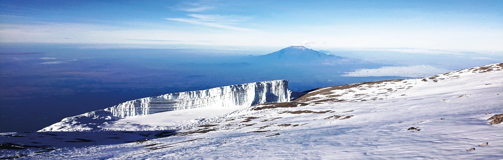 Glaciers along the route between Stella Point and Uhuru Peak with Mount Meru visible in the distance