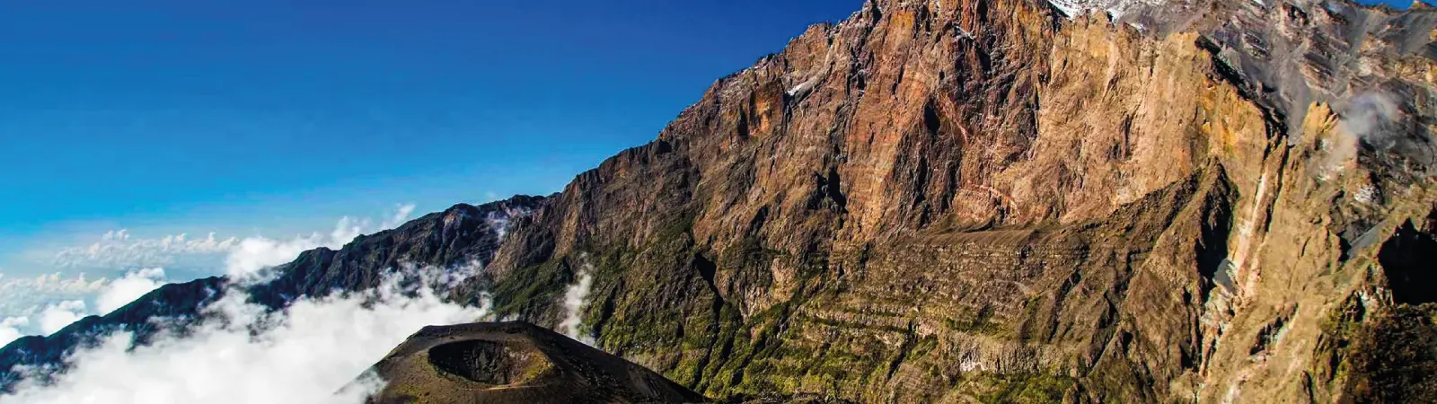 The dramatic volcanic peak and crater of Mount Meru in Arusha National Park, Tanzania.