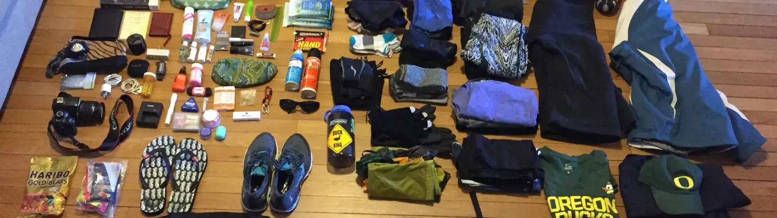 Organized essential gear, boots, and clothing laid out for a complete Tanzania safari and trekking packing list.