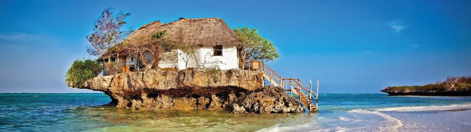 The well-known Rock Restaurant sits on a coral rock surrounded by the sea when the tide is high in Zanzibar.